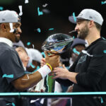 Feb 9, 2025; New Orleans, LA, USA; Philadelphia Eagles quarterback Jalen Hurts (1) passes the Vince Lombardi Trophy to Philadelphia Eagles head coach Nick Sirianni after defeating the Kansas City Chiefs in Super Bowl LIX at Ceasars Superdome. Mandatory Credit: Mark J. Rebilas-Imagn Images