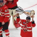 Feb 20, 2025; Boston, MA, USA; [Imagn Images direct customers only] Team Canadá forward Brad Marchand (63) lifts the 4 Nations Face-Off trophy after winning against Team USA in overtime during the 4 Nations Face-Off ice hockey championship game at TD Garden. Mandatory Credit: Brian Fluharty-Imagn Images