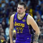 Feb 22, 2025; Denver, Colorado, USA; Los Angeles Lakers guard Luka Doncic (77) celebrates after a basket during the first half against the Denver Nuggets at Ball Arena.