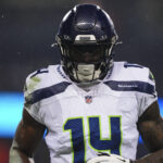 CHICAGO, IL - DECEMBER 26: DK Metcalf #14 of the Seattle Seahawks runs across the field during an NFL football game against the Chicago Bears at Soldier Field on December 26, 2024 in Chicago, Illinois. (Photo by Cooper Neill/Getty Images)