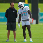 Aug 17, 2022; Miami Gardens, Florida, US; Miami Dolphins head coach Mike McDaniel talks with Miami Dolphins wide receiver Tyreek Hill (10) during practice at Baptist Health Training Complex.