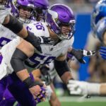 Minnesota Vikings center Garrett Bradbury (56) protects his quarterback during a play against the Detroit Lions defense at Ford Field in Detroit on Sunday, Jan. 7, 2024.
