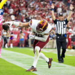 Sep 29, 2024; Glendale, Arizona, USA; Washington Commanders tight end Zach Ertz (86) spikes the ball as he celebrates a two point conversion against the Arizona Cardinals in the second half at State Farm Stadium. Mandatory Credit: Mark J. Rebilas-Imagn Images