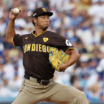 Oct 11, 2024; Los Angeles, California, USA; San Diego Padres pitcher Yu Darvish (11) pitches against the Los Angeles Dodgers in the first inning during game five of the NLDS for the 2024 MLB Playoffs at Dodger Stadium. Mandatory Credit: Kiyoshi Mio-Imagn Images