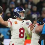 Nov 10, 2024; Munich, Germany; New York Giants quarterback Daniel Jones (8) throws the ball against the Carolina Panthers in the second half during the 2024 NFL Munich Game at Allianz Arena. Mandatory Credit: Kirby Lee-Imagn Images