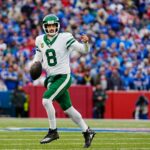 New York Jets quarterback Aaron Rodgers (8) breaks away on a fake hand-off looking for an open receiver during first half action at the Bills home game against the New York Jets at Highmark Stadium in Orchard Park on Dec. 29, 2024. His pass was incomplete.
