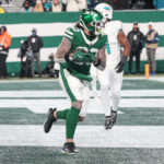 Jan 5, 2025; East Rutherford, New Jersey, USA; New York Jets tight end Tyler Conklin (83) catches a touchdown pass from quarterback Aaron Rodgers (not pictured) during the first half against the Miami Dolphins at MetLife Stadium. Mandatory Credit: Vincent Carchietta-Imagn Images