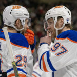 Jan 15, 2025; Saint Paul, Minnesota, USA; Edmonton Oilers forward Leon Draisaitl (29) and forward Connor McDavid (97) talk before a face-off against the Minnesota Wild during the third period at Xcel Energy Center. Mandatory Credit: Nick Wosika-Imagn Images