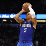 Feb 27, 2025; Orlando, Florida, USA; Orlando Magic forward Paolo Banchero (5) shoots a three point shot against the Golden State Warriors in the second quarter at Kia Center. Mandatory Credit: Nathan Ray Seebeck-Imagn Images