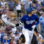 Feb 28, 2025; Phoenix, Arizona, USA; Los Angeles Dodgers designated hitter Shohei Ohtani (17) tosses his bat affter hitting a leadoff home run against the Los Angeles Angels during a spring training game at Camelback Ranch-Glendale. Mandatory Credit: Mark J. Rebilas-Imagn Images