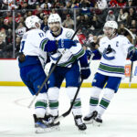 Mar 24, 2025; Newark, New Jersey, USA; Vancouver Canucks left wing Jake DeBrusk (74) reacts after a goal by Vancouver Canucks center Pius Suter (not pictured) during the third period against the New Jersey Devils at Prudential Center. Mandatory Credit: John Jones-Imagn Images