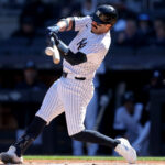 Mar 27, 2025; Bronx, New York, USA; New York Yankees catcher Austin Wells (28) hits a solo home run against the Milwaukee Brewers during the first inning at Yankee Stadium.