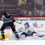 Mar 27, 2025; San Jose, California, USA; San Jose Sharks center Macklin Celebrini (71) scores past Toronto Maple Leafs goaltender Joseph Woll (60) during a shootout at SAP Center at San Jose. The Sharks won 6-5. Mandatory Credit: D. Ross Cameron-Imagn Images