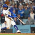 Mar 28, 2025; Los Angeles, California, USA; Los Angeles Dodgers shortstop Mookie Betts (50) hits a 3 run home run during the tenth inning against the Detroit Tigers at Dodger Stadium. Mandatory Credit: Kirby Lee-Imagn Images