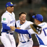 TUCSON, ARIZONA - MARCH 06: Leonardo Reginatto #5 of Brazil celebrates with Lucas Rojo #15 and Victor Mascai #17 after Brazil defeated Germany 6-4 during game seven of the World Baseball Classic Qualifiers to qualify for the 2026 World Baseball Classic at Kino Veterans Memorial Stadium on March 06, 2025 in Tucson, Arizona.
