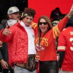 Feb 15, 2023; Kansas City, Missouri, USA; Kansas City Chiefs quarterback Patrick Mahomes (15) celebrates with his mother Randi Martin during the Kansas City Chiefs Super Bowl parade. Mandatory Credit: Denny Medley-USA TODAY Sports