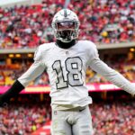 Dec 25, 2023; Kansas City, Missouri, USA; Las Vegas Raiders cornerback Jack Jones (18) interacts with the crowd after a play during the second half against the Kansas City Chiefs at GEHA Field at Arrowhead Stadium. Mandatory Credit: Jay Biggerstaff-USA TODAY Sports