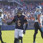 Oct 6, 2024; Chicago, Illinois, USA; Chicago Bears cornerback Kyler Gordon (6) recovers a fumble against the Carolina Panthers during the second half at Soldier Field. Mandatory Credit: David Banks-Imagn Images