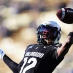 Nov 29, 2024; Boulder, Colorado, USA; Colorado Buffaloes wide receiver Travis Hunter (12) warms up before the game against the Oklahoma State Cowboys at Folsom Field. Mandatory Credit: Ron Chenoy-Imagn Images