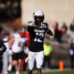 Nov 29, 2024; Boulder, Colorado, USA; Colorado Buffaloes wide receiver Travis Hunter (12) celebrates his first down reception in the fourth quarter against the Oklahoma State Cowboys at Folsom Field. Mandatory Credit: Ron Chenoy-Imagn Images