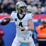 Dec 8, 2024; East Rutherford, New Jersey, USA; New Orleans Saints quarterback Derek Carr (4) drops back to pass against the New York Giants during the first quarter at MetLife Stadium.