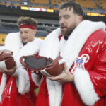 Dec 25, 2024; Pittsburgh, Pennsylvania, USA; Kansas City Chiefs quarterback Patrick Mahomes (left) and tight end Travis Kelce (right) open their Netflix Christmas GameDay cake after the Chiefs defeated the Pittsburgh Steelers at Acrisure Stadium. Mandatory Credit: Charles LeClaire-Imagn Images NFL