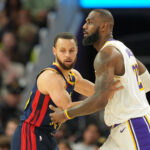 Jan 25, 2025; San Francisco, California, USA; Golden State Warriors guard Stephen Curry (left) defends against Los Angeles Lakers forward LeBron James (right) during the fourth quarter at Chase Center.