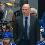 Feb 4, 2025; Vancouver, British Columbia, CAN; Vancouver Canucks head coach Rick Tocchet on the bench against the Colorado Avalanche in the first period at Rogers Arena. Mandatory Credit: Bob Frid-Imagn Images