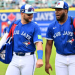 Feb 25, 2025; Dunedin, Florida, USA; Toronto Blue Jays shortstop Bo Bichette (11) and designated hitter Vladimir Guerrero Jr. (27) walk towards the dugout before a spring training game against the St. Louis Cardinals at TD Ballpark. Mandatory Credit: Jonathan Dyer-Imagn Images