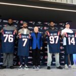 NFL Free Agency - Mar 13, 2025; Foxborough, MA, USA; The New England Patriots hold a press conference at the GP Atrium at Gillette Stadium to introduce free agency additions to the team. (Left to right) New England Patriots head coach Mike Vrabel, offensive tackle Morgan Moses, cornerback Carlton Davis III, owner Robert Kraft, defensive tackle Milton Williams, linebacker Robert Spillane and executive vice president of player personnel Eliot Wolf. Mandatory Credit: Eric Canha-Imagn Images