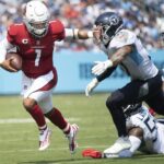 Arizona Cardinals quarterback Kyler Murray (1) scrambles away from Tennessee Titans safety Amani Hooker (37) and linebacker Harold Landry (58) at Nissan Stadium in Nashville on Sept. 12, 2021. The Titans lost their home and season opener 38-13.