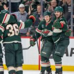 Apr 6, 2025; Saint Paul, Minnesota, USA; Minnesota Wild center Marco Rossi (23) is congratulated by teammates after scoring the game winning goal in overtime agains the Dallas Stars at Xcel Energy Center. Mandatory Credit: Matt Blewett-Imagn Images