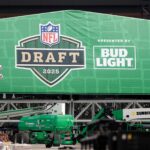 Crews work to raise the roof of the NFL draft theater on April 9, 2025, in the parking lot of Lambeau Field in Green Bay, Wis.