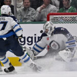 Apr 10, 2025; Dallas, Texas, USA; Winnipeg Jets goaltender Connor Hellebuyck (37) stops a breakaway shot by Dallas Stars right wing Mikko Rantanen (96) during the third period at the American Airlines Center. Mandatory Credit: Jerome Miron-Imagn Images