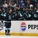Apr 15, 2025; Seattle, Washington, USA; Seattle Kraken defenseman Brandon Montour (62) celebrates with the bench after scoring a goal against the Los Angeles Kings during the second period at Climate Pledge Arena. Mandatory Credit: Steven Bisig-Imagn Images
