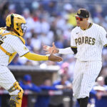 Apr 16, 2025; San Diego, California, USA; San Diego Padres third baseman Manny Machado (13), right, is congratulated by Elias Diaz (17) after throwing Chicago Cubs first baseman Michael Busch (29) at first base during the ninth inning at Petco Park. Mandatory Credit: Denis Poroy-Imagn Images