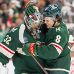 Apr 24, 2025; Saint Paul, Minnesota, USA; Minnesota Wild defenseman Zeev Buium (8) congratulates Minnesota Wild goaltender Filip Gustavsson (32) after after the final buzzer sounded and the Wild defeated the Vegas Golden Knights in game three of the first round of the 2025 Stanley Cup Playoffs at Xcel Energy Center. Mandatory Credit: Matt Blewett-Imagn Images