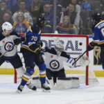 Apr 27, 2025; St. Louis, Missouri, USA; Winnipeg Jets goaltender Connor Hellebuyck (37) gives up a goal to St. Louis Blues left wing Jake Neighbours (63) during the first period in game four of the first round of the 2025 Stanley Cup Playoffs at Enterprise Center. Mandatory Credit: Jeff Le-Imagn Images