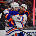 Apr 29, 2025; Los Angeles, California, USA; Edmonton Oilers center Ryan Nugent-Hopkins (93) celebrates his empty net goal scored against the Los Angeles Kings with center Connor McDavid (97) during the third period in game five of the first round of the 2025 Stanley Cup Playoffs at Crypto.com Arena. Mandatory Credit: Gary A. Vasquez-Imagn Images