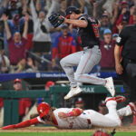 Apr 29, 2025; Philadelphia, Pennsylvania, USA; Washington Nationals pitcher Kyle Finnegan (67) jumps over Philadelphia Phillies second base Bryson Stott (5) after he scored the winning run on a wild pitch during the ninth inning at Citizens Bank Park.