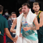 Aug 7, 2021; Saitama, Japan; Team Slovenia point guard Luka Doncic (77) shakes hands with Australia players and coaches after their game during the Tokyo 2020 Olympic Summer Games at Saitama Super Arena.