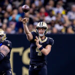 Dec 1, 2024; New Orleans, Louisiana, USA; New Orleans Saints quarterback Derek Carr (4) passes against the Los Angeles Rams during the first half at Caesars Superdome. Mandatory Credit: Stephen Lew-Imagn Images