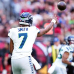 Dec 8, 2024; Glendale, Arizona, USA; Seattle Seahawks quarterback Geno Smith (7) throws against the Arizona Cardinals during the first half at State Farm Stadium. Mandatory Credit: Joe Camporeale-Imagn Images
