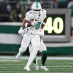 Jan 5, 2025; East Rutherford, New Jersey, USA; Miami Dolphins tight end Jonnu Smith (9) fights for yards during the second half against the New York Jets at MetLife Stadium. Mandatory Credit: Vincent Carchietta-Imagn Images