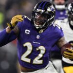Jan 11, 2025; Baltimore, Maryland, USA; Baltimore Ravens running back Derrick Henry (22) runs against Pittsburgh Steelers linebacker Elandon Roberts (50) in the second quarter in an AFC wild card game at M&T Bank Stadium.