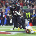 Jan 11, 2025; Houston, Texas, USA; Houston Texans wide receiver Nico Collins (12) runs with the ball after a reception during the game against the Los Angeles Chargers in an AFC wild card game at NRG Stadium. Mandatory Credit: Troy Taormina-Imagn Images