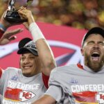 Kansas City Chiefs quarterback Patrick Mahomes (15) raises the Lamar Hunt Trophy with tight end Travis Kelce (87) after the AFC championship NFL game between the Cincinnati Bengals and the Kansas City Chiefs on Jan. 29, 2023, at Arrowhead Stadium in Kansas City.