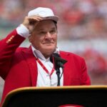 An emotional Cincinnati Reds hall of famer Pete Rose adjusts his cap as he takes the microphone during a pregame ceremony for the unveiling of Pete Rose's bronze statue being installed outside the stadium before the MLB National League game between the Cincinnati Reds and the Los Angeles Dodgers at Great American Ball Park in downtown Cincinnati on Saturday, June 17, 2017.