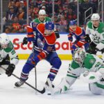 Mar 26, 2025; Edmonton, Alberta, CAN; Dallas Stars goaltender Jake Oettinger (29) makes a save on Edmonton Oilers forward Ryan Nugent-Hopkins (93) during the third period at Rogers Place. Mandatory Credit: Perry Nelson-Imagn Images