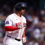 May 8, 2025; Boston, Massachusetts, USA; Boston Red Sox designated hitter Rafael Devers (11) hits a home run against the Texas Rangers in the seventh inning at Fenway Park. Mandatory Credit: David Butler II-Imagn Images